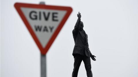 The statue of Edward Carson at Stormont is seen next to a road sign, in Belfast, Northern Ireland June 27, 2017.