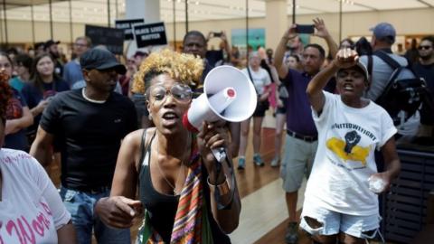 Protesters march through the West County Center in St Louis' Des Peres suburb. Photo: 16 September 2017