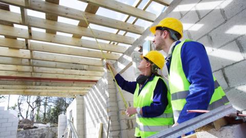 A man and a woman on a house building site