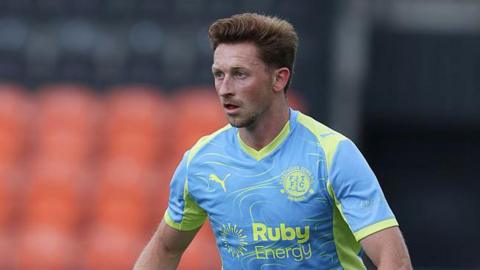 Denver Hume on the pitch, wearing a blue and yellow Fleetwood Town shirt in August 2025