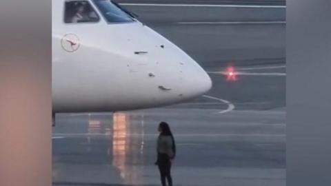 A woman on the tarmac at Canberra airport