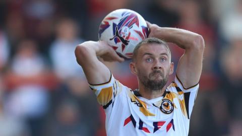 Newport County's Shane McLoughlin takes a throw in