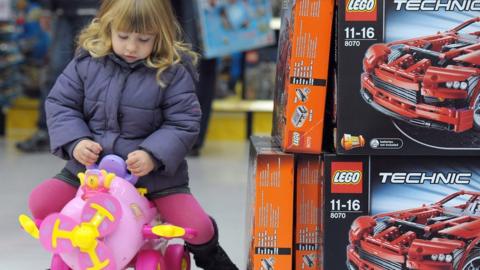 File pic of girl playing with toy in a store in France