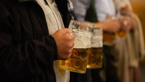 A man drinks beer at Oktoberfest