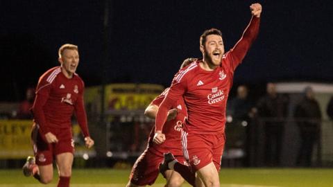 Aron Williams celebrates his late goal for Connah's Quay