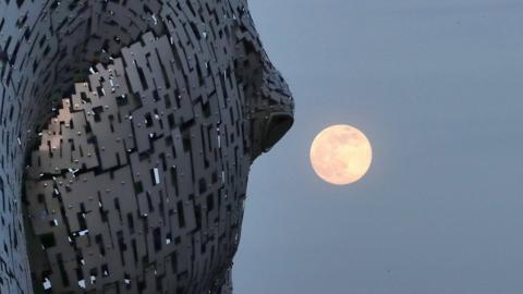 A pink supermoon is seen over the Kelpies sculpture in Falkirk