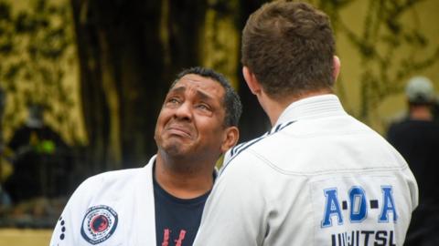 Mourners in Jiu-Jitsu uniforms attend the wake of Leandro Lo on 8 August 2022