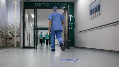 Staff walking along a corridor at Grange Hospital, Cwmbran