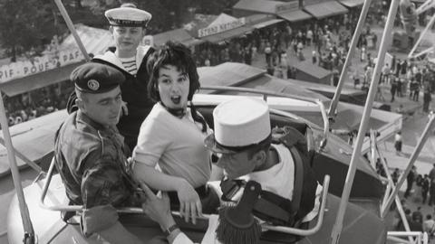 A woman on a fairground ride with three men