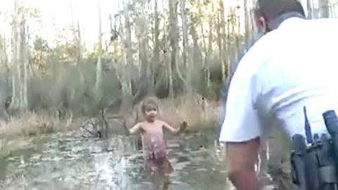 Girl in swamp and law enforcement official