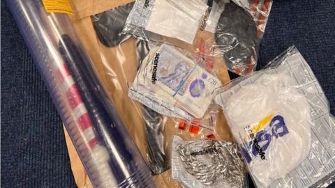 Drugs, cash, weapons and designer jewellery and clothing were found during police raids