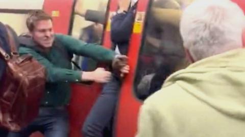 Man tries to pry open Tube doors for panicked passengers stuck inside carriage.