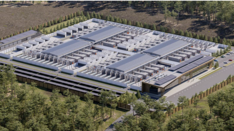 A computer-generated image of the design of a data centre, showing a rectangular area of low-level grey-roofed buildings and solar panels. The area is surrounded by trees and grassland. 