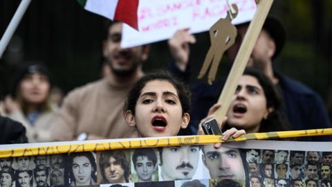 People protest outside the Iranian embassy in Rome on 10 December 2022