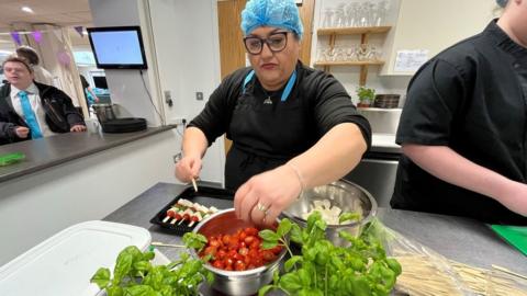 A chef prepares food in the kitchen