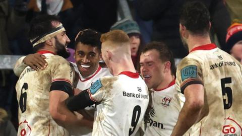 Robert Baloucoune is mobbed by team-mates after scoring a try