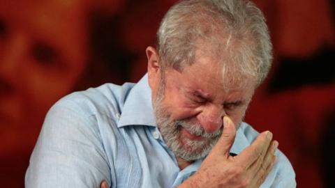 Former Brazilian president Luiz Inacio Lula da Silva reacts as he attends a meeting with members of the Workers Party (PT), that decided Lula da Silva will be its candidate again in the 2018 election