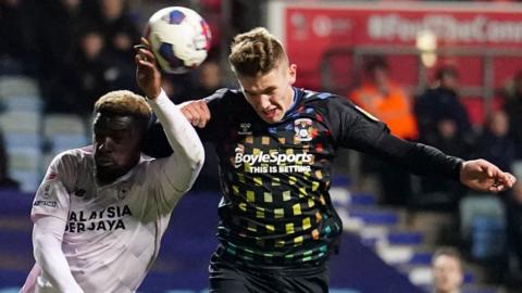 Coventry City's Viktor Gyokeres heads wide under pressure from Cardiff City's Cedric Kipre