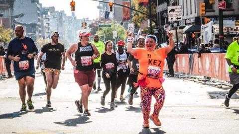 Kerrie Aldridge running marathon with arms above head