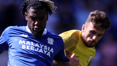 Cedric Kipre (left) of Cardiff City is challenged by Troy Parrott of Preston North End