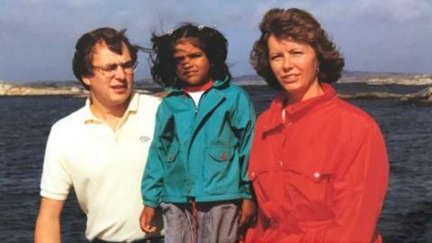 A young Kiran with her parents