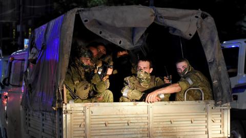 Members of the Wagner Group prepare to depart from the Southern Military District's headquarters and return to their base on 24 June 2023 in Rostov-on-Don, Russia