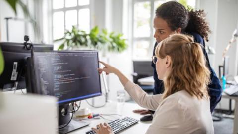 Office workers looking at a computer screen