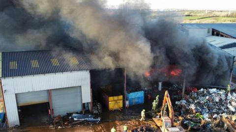 The blaze, in Waterston, Milford Haven, is about 25m x 50m (80ft x160ft) big, say fire crews