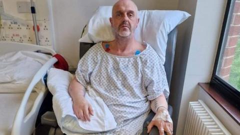Stroke patient Gavin Matthews by his hospital bed