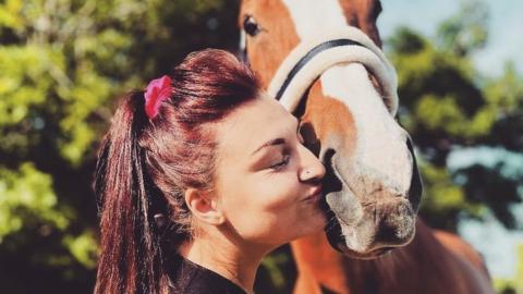 Jade Randall kissing a horse