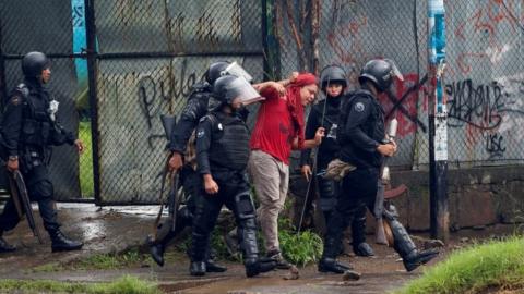 Riot police officers detain a demonstrator during a protest against Nicaragua"s President Daniel Ortega"s government in Managua, May 28, 2018