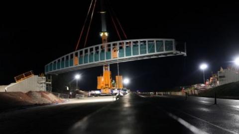 The bridge being installed over the A30 at Chiverton