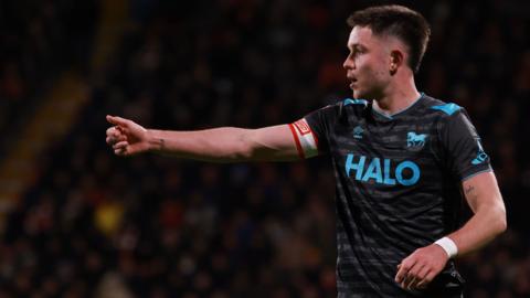 Ipswich's George Hirst pointing arm in away kit