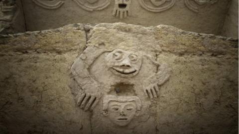 An undated handout photo made available by Archaeological Area Caral shows a humanized toad and an anthropomorphic head, discovered in one of the buildings of the civilization of Caral, north of Lima