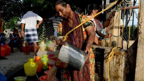 Woman pours water into pots