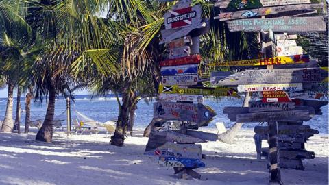 Signs on a beach on the Cayman Islands
