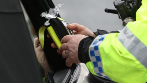 Police officer with breathalyser