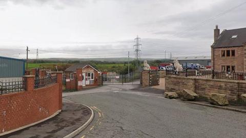 A commercial site on Meadow Street, Great Harwood, showing green fields in the background.