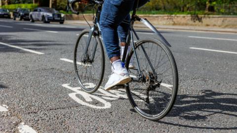 A person cycling in a cycle lane.