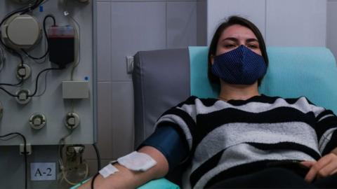 Kristina, (21years old) who recovered from COVID -19 donates her plasma via plasmapheresis method at the Regional Center of Blood Donation and Blood Treatment on November 10, 2020 in Krakow, Poland.