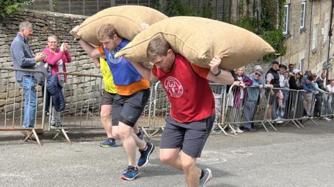 Men carrying a sack on his shoulders