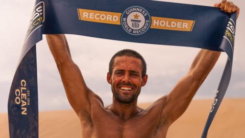 Spencer Matthews holding a Guinness World Records banner