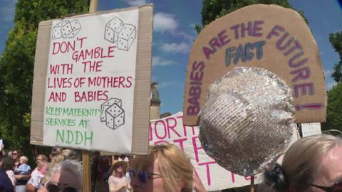A view of two signs at the protest.