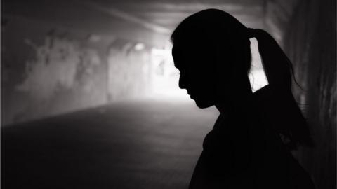 Silhouette young women in the tunnel