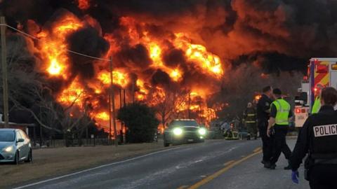 A fire is seen at the place of the train and truck collision in Cameron, Texas, U.S., February 23, 2021, in this still image obtained from a social media video