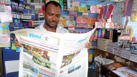 A Yemeni man reads a newspaper in the southern Yemeni city of Aden on April 10, 2016