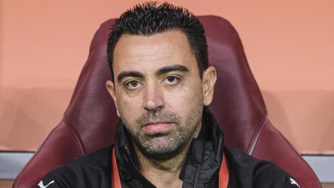 Former Barcelona and Spain midfielder Xavi sits on the bench while in charge of Qatari side Al Sadd