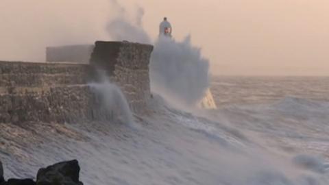 wave crashing against lighthouse