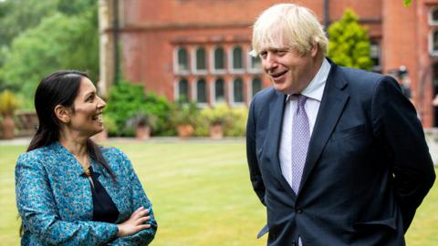 Prime Minister Boris Johnson, with Home Secretary Priti Patel, during a visit to Surrey Police headquarters on July 27, 2021 in Guildford, United Kingdom