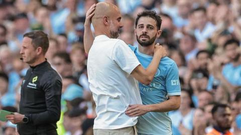 Pep Guardiola, manager of Manchester City, embraces Bernardo Silva